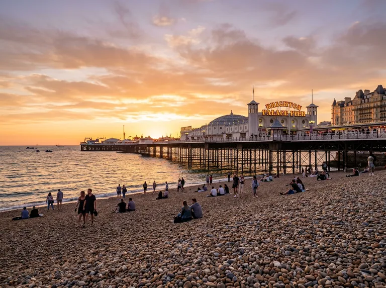 Brighton seafront at golden hour with the pier and the beach