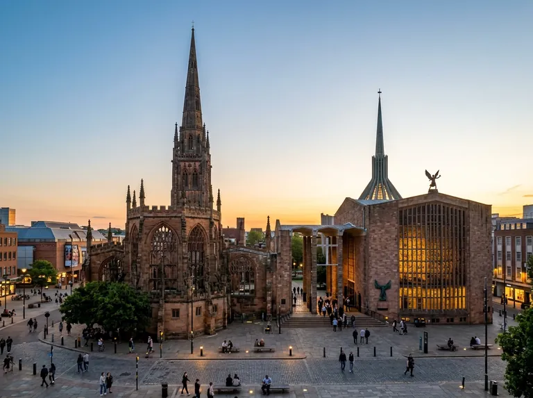 Coventry city centre with the old cathedral ruins and the modern cathedral on a clear evening
