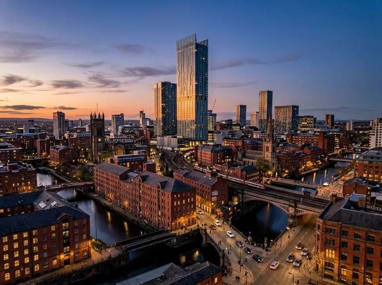 Manchester skyline at dusk with Beetham Tower, Deansgate and red brick warehouses
